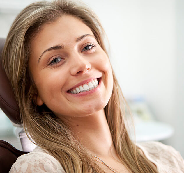 smiling woman sitting in a dental chair