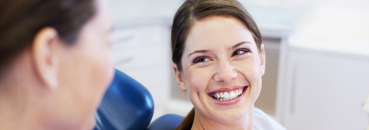 smiling woman sitting in a dental chair