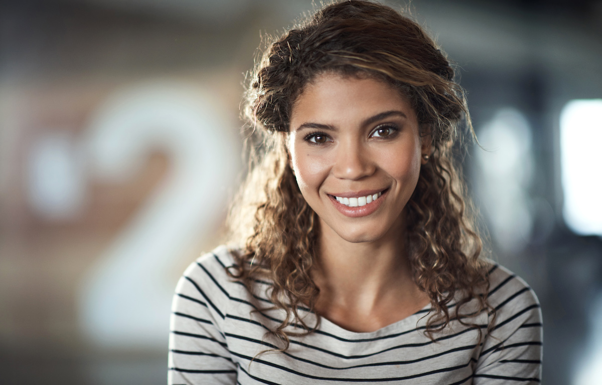 Headshot of a smiling curly-haired woman wearing a striped shirt at edgewood family dentistry, a dentist in Anderson, IN