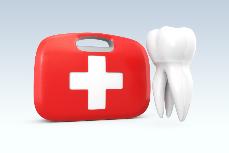 A white tooth floats next to a red and white first aid kit to indicate a dental emergency at edgewood family dentistry, a dentist in Anderson, IN