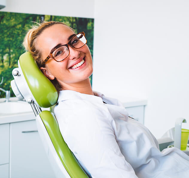 smiling woman sitting in a dental chair