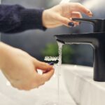 woman rinsing invisalign aligners